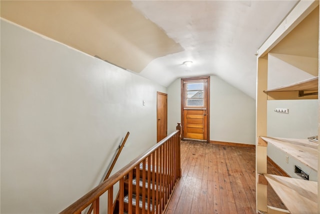 interior space with hardwood / wood-style flooring and lofted ceiling