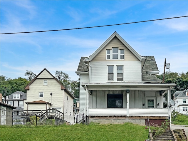 back of house with a yard and a porch