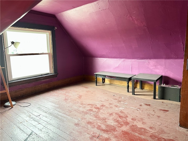 additional living space featuring vaulted ceiling and hardwood / wood-style floors