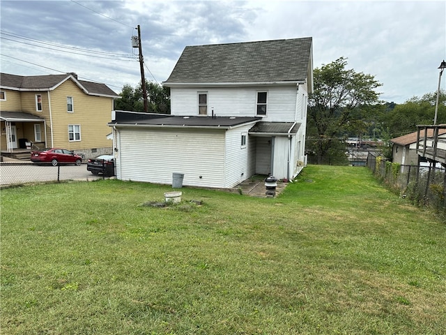 rear view of property with a yard