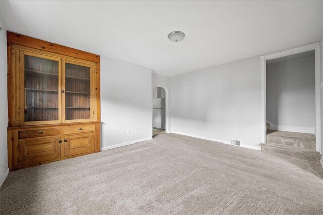 empty room with light colored carpet