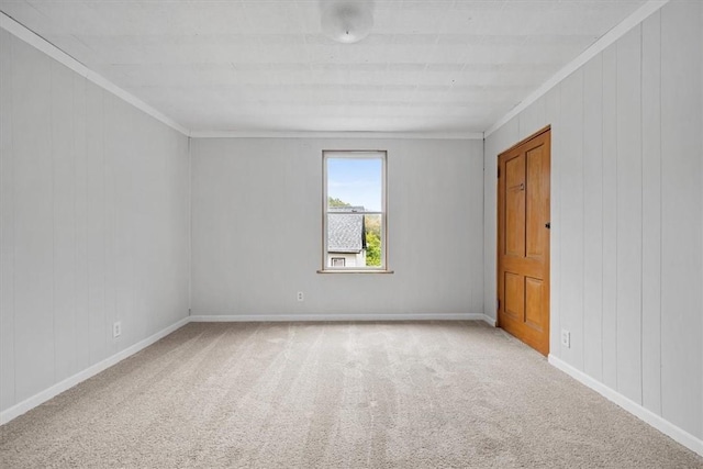 carpeted spare room with crown molding