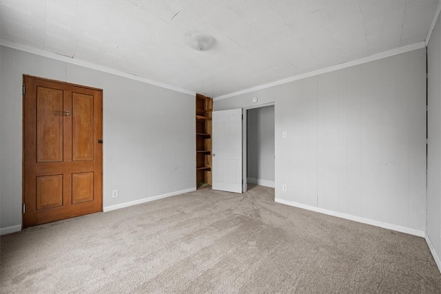 carpeted spare room with crown molding