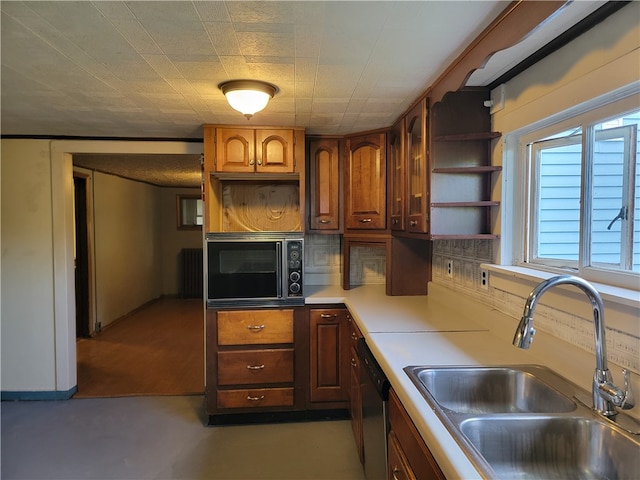 kitchen featuring sink, radiator heating unit, and stainless steel appliances