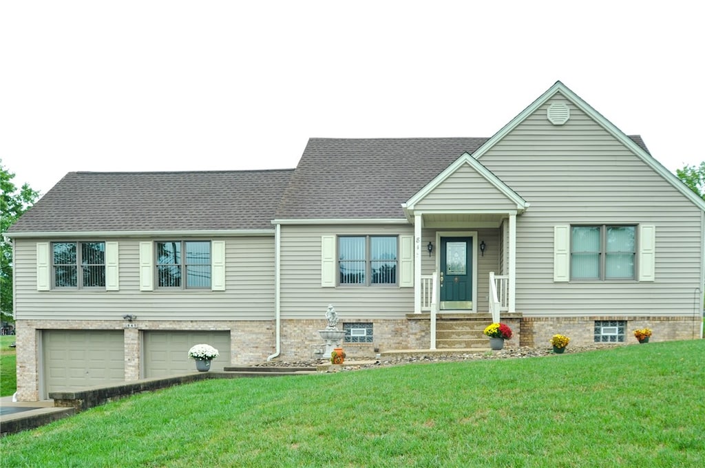 view of front of home with a garage and a front yard