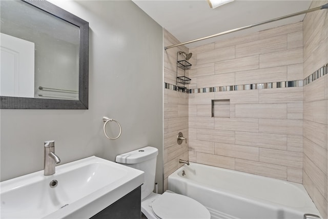 full bathroom featuring vanity, toilet, and tiled shower / bath