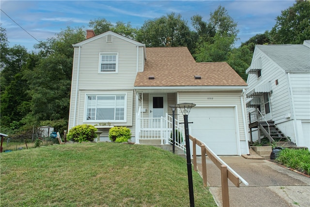 view of front of property with a garage and a front lawn