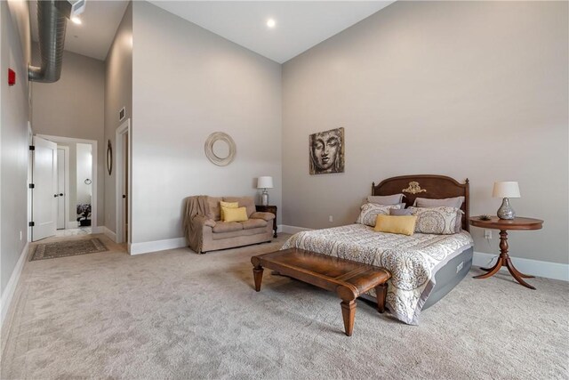 carpeted bedroom featuring high vaulted ceiling