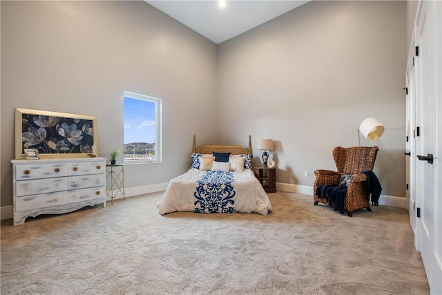 carpeted bedroom featuring high vaulted ceiling