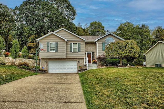 raised ranch with cooling unit, a front lawn, and a garage