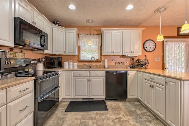 kitchen featuring white cabinets, hanging light fixtures, sink, and black appliances