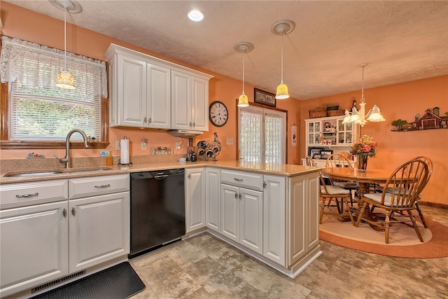 kitchen featuring white cabinets, dishwasher, pendant lighting, and kitchen peninsula