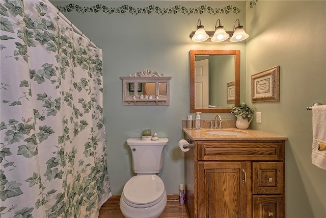 bathroom featuring walk in shower, vanity, hardwood / wood-style floors, and toilet