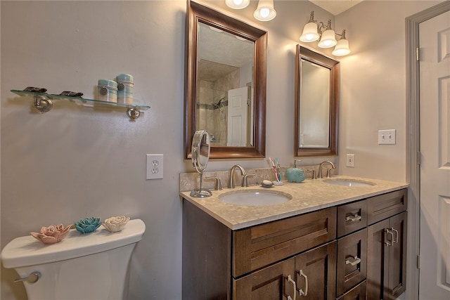 bathroom featuring a shower, vanity, and toilet