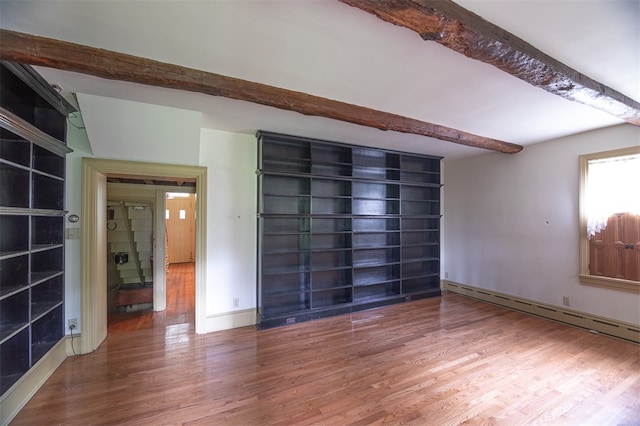 spare room with beam ceiling, baseboard heating, and hardwood / wood-style flooring