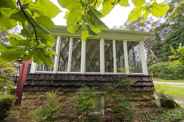 view of home's exterior with a sunroom