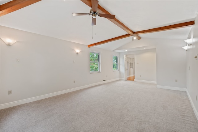 spare room with vaulted ceiling with beams, ceiling fan, and light colored carpet