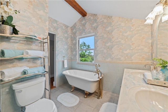 bathroom featuring tile walls, toilet, vaulted ceiling with beams, vanity, and a bathing tub