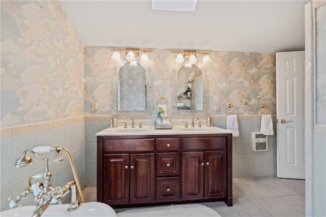 bathroom with tile walls, heating unit, tile patterned flooring, and vanity