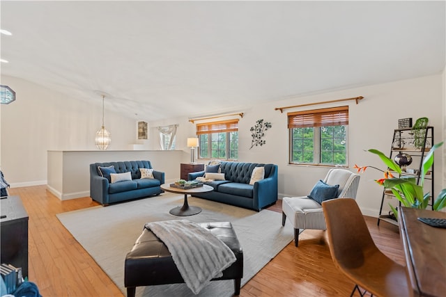 living room featuring a notable chandelier and light hardwood / wood-style flooring