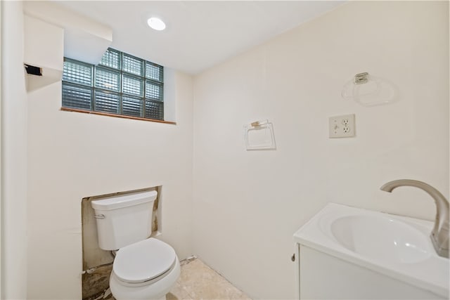 bathroom with tile patterned flooring, vanity, and toilet