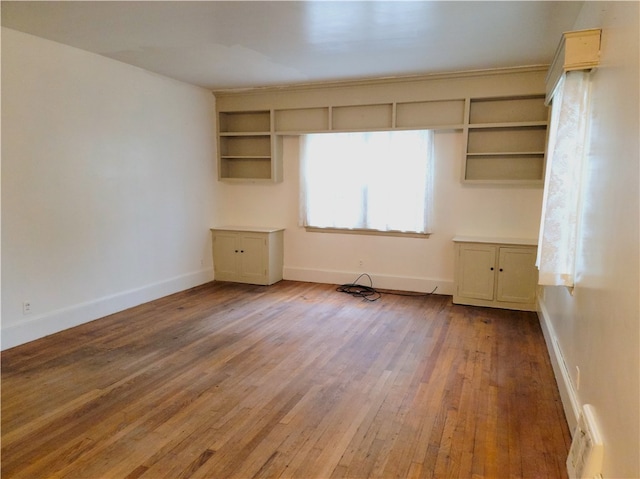 spare room with wood-type flooring