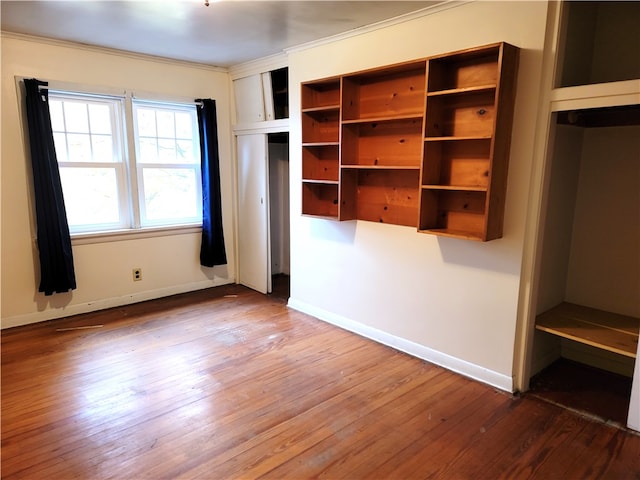 unfurnished bedroom featuring ornamental molding and hardwood / wood-style floors