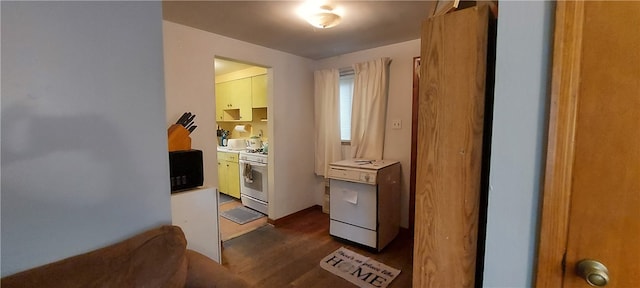 kitchen featuring dark wood-type flooring and white gas range oven