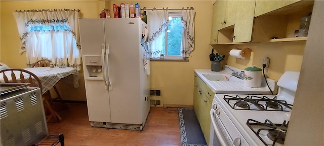 kitchen featuring light hardwood / wood-style flooring, white appliances, and sink