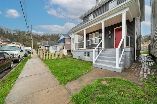 view of front of home with a front lawn and a porch