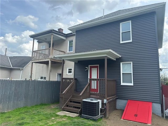 rear view of house with central AC unit