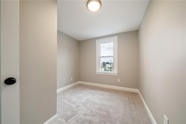 spare room featuring light colored carpet