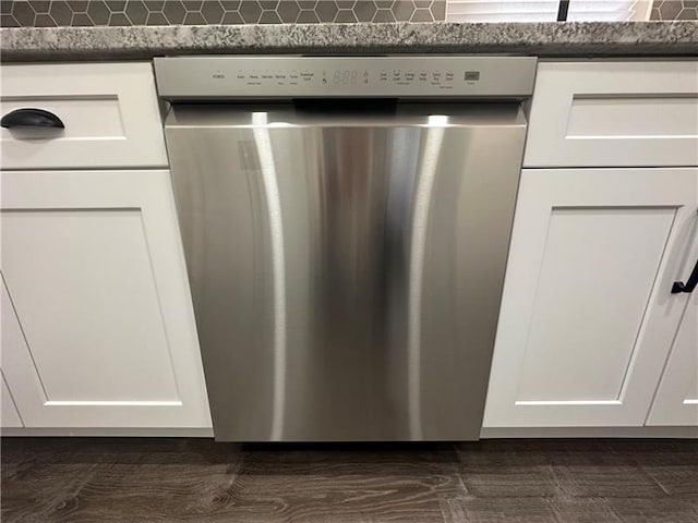 details featuring white cabinetry and stainless steel dishwasher