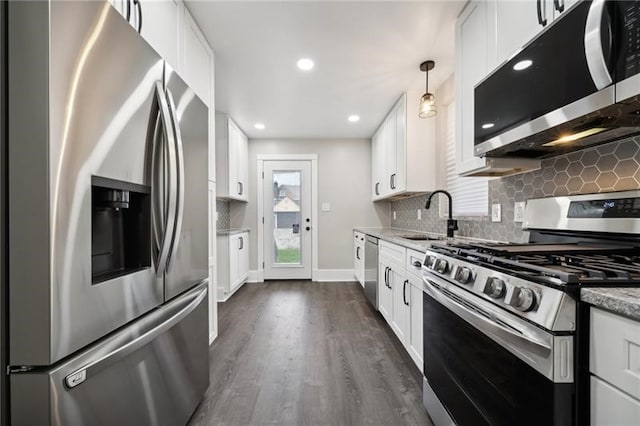 kitchen featuring stainless steel appliances, white cabinets, sink, and dark hardwood / wood-style flooring