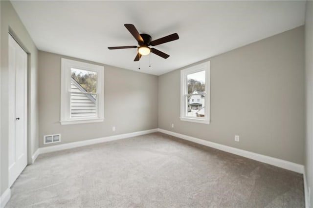 unfurnished bedroom featuring ceiling fan and light colored carpet