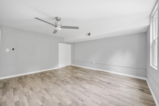 spare room with light hardwood / wood-style floors and ceiling fan