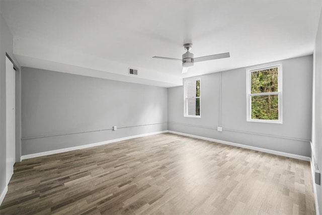 spare room with ceiling fan and hardwood / wood-style flooring