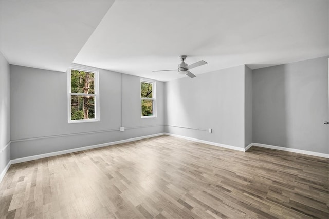 unfurnished room with ceiling fan and hardwood / wood-style floors