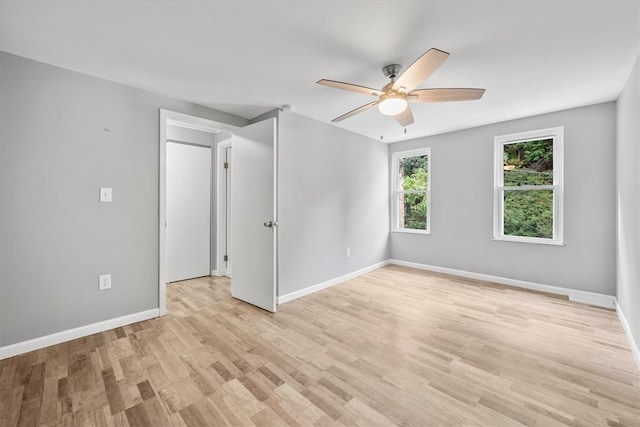 empty room featuring light wood-type flooring and ceiling fan