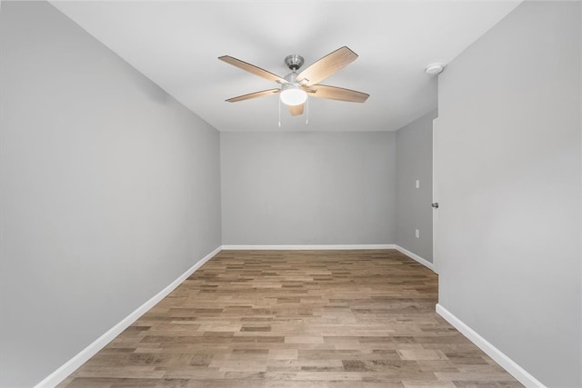 empty room with ceiling fan and light hardwood / wood-style flooring