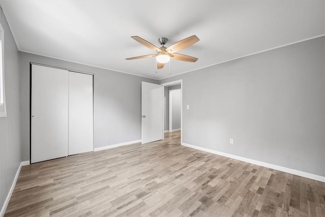 unfurnished bedroom featuring ceiling fan, light hardwood / wood-style flooring, and a closet