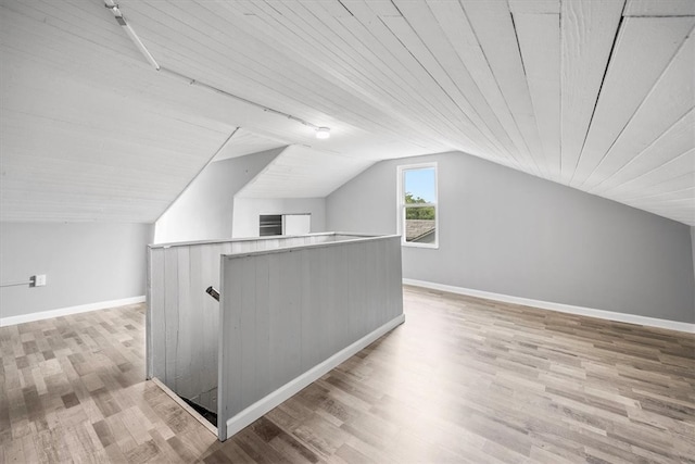 additional living space with light wood-type flooring, wood ceiling, and lofted ceiling