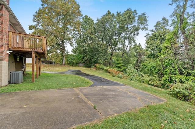 view of yard featuring central AC and a wooden deck