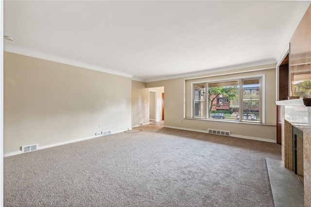 unfurnished living room featuring carpet and crown molding