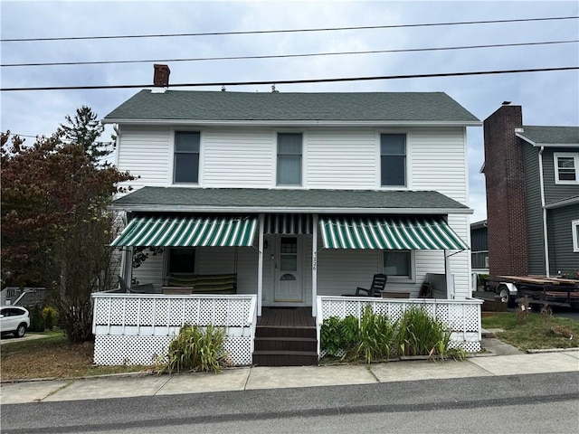 view of front of home featuring a porch and a shingled roof
