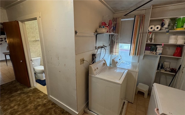 clothes washing area featuring separate washer and dryer