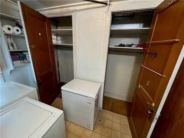 clothes washing area with washer and clothes dryer