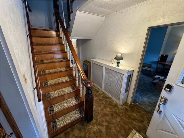 stairway with carpet flooring and vaulted ceiling