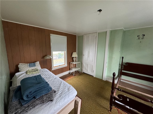 bedroom featuring wooden walls