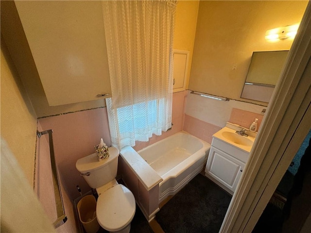 bathroom featuring vanity, a garden tub, and toilet